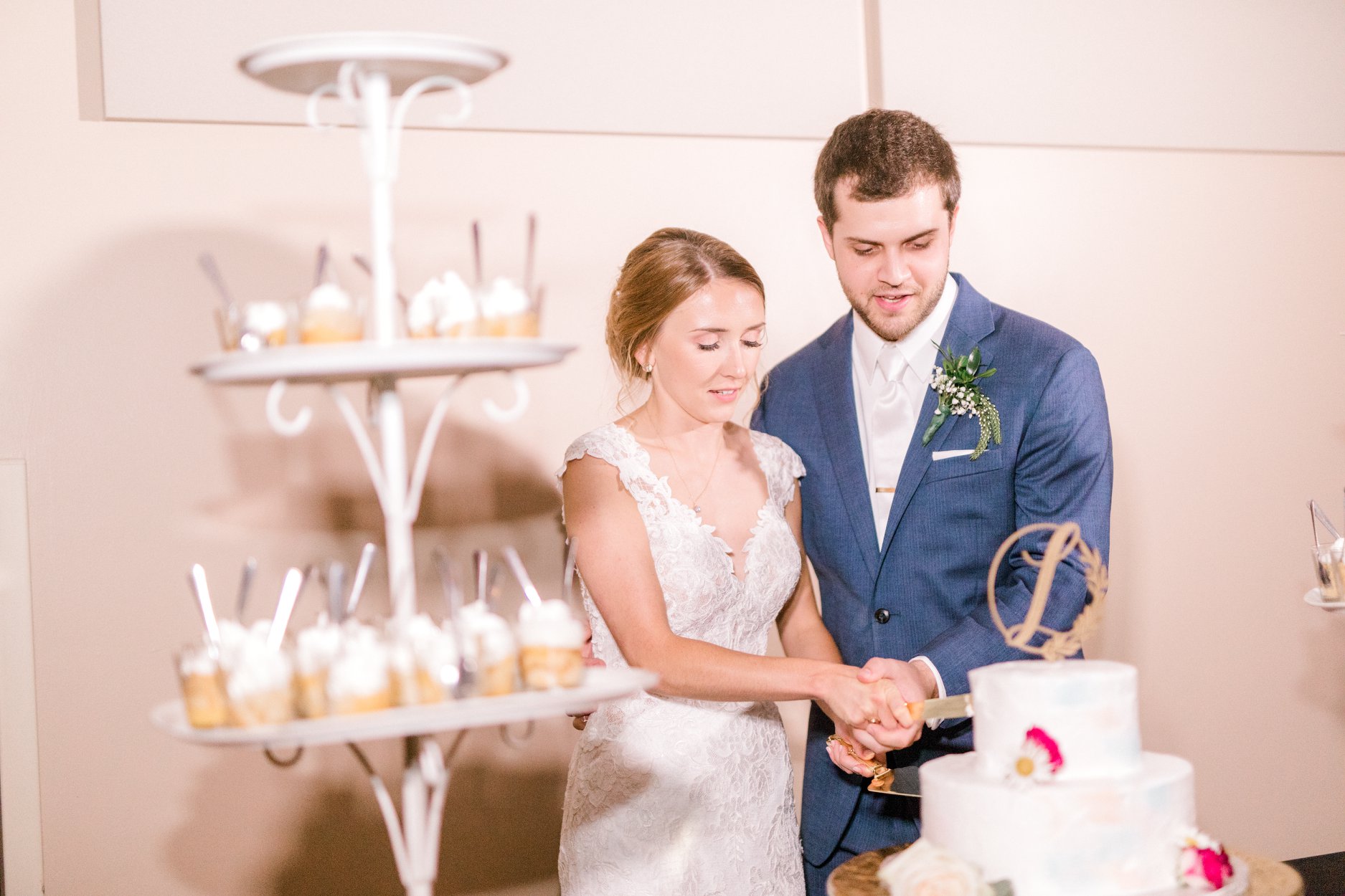 bride and groom cutting wedding cake